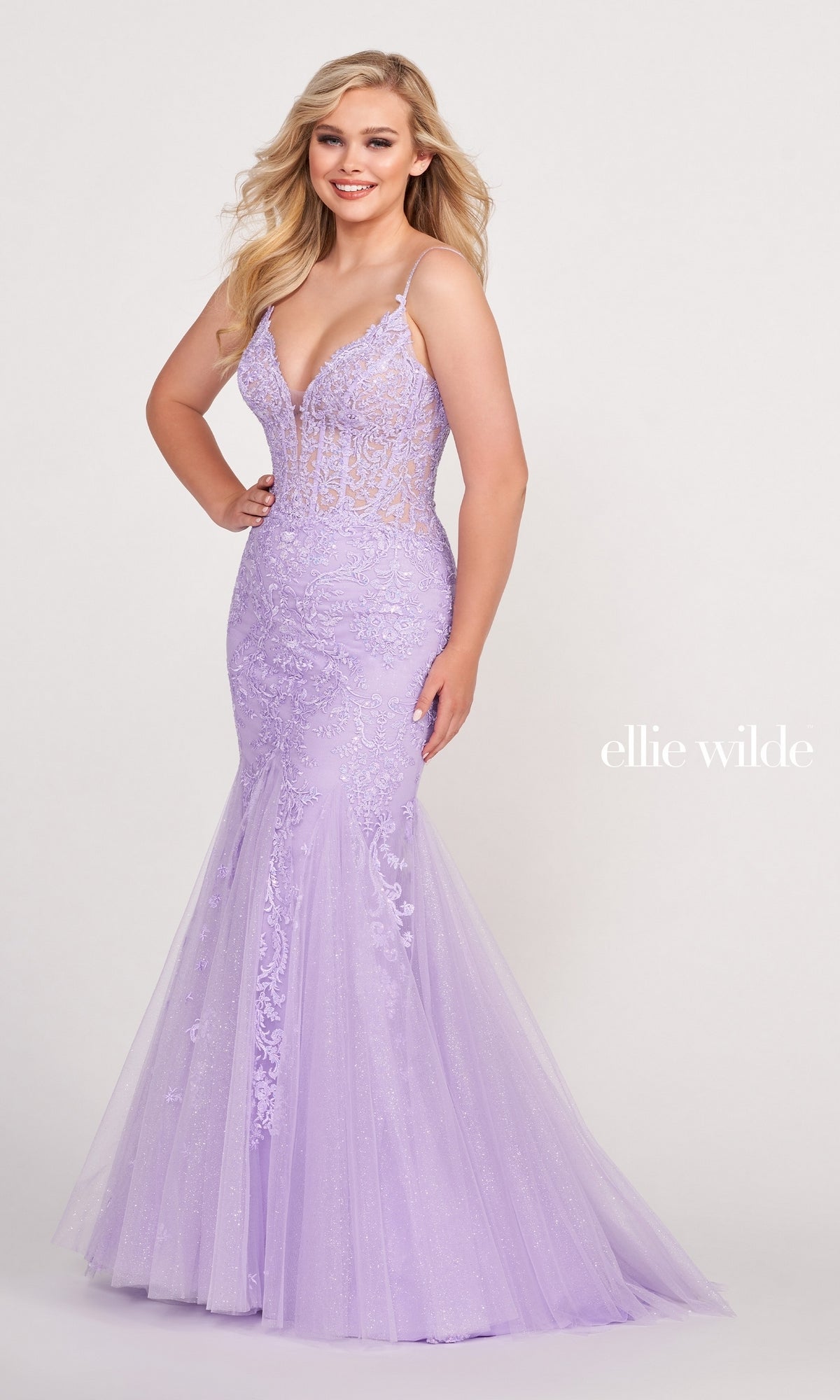 A woman wears the Sheer-Bodice Embroidered Long Mermaid Prom Dress in light purple with lace embellishments and a sheer bodice.